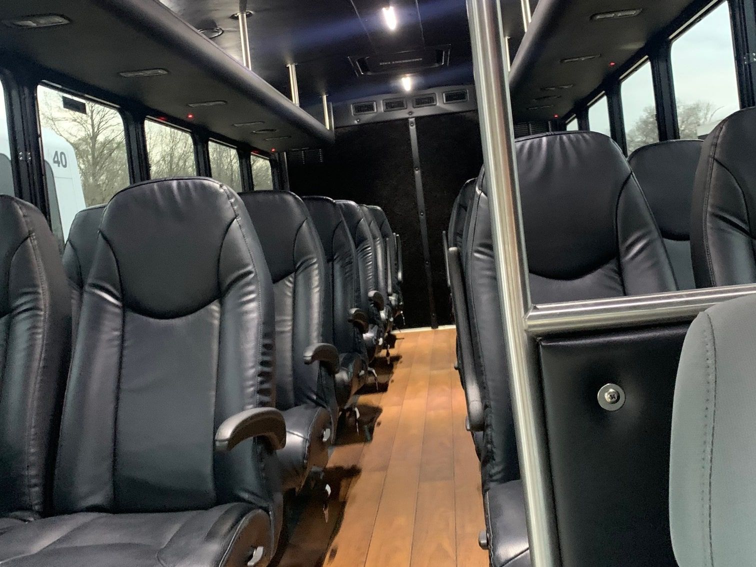 28 passenger minibus interior with leather seats and wood-look floor