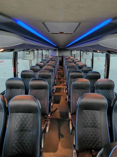 Setra charter bus interior with leather seats and blue accent lighting